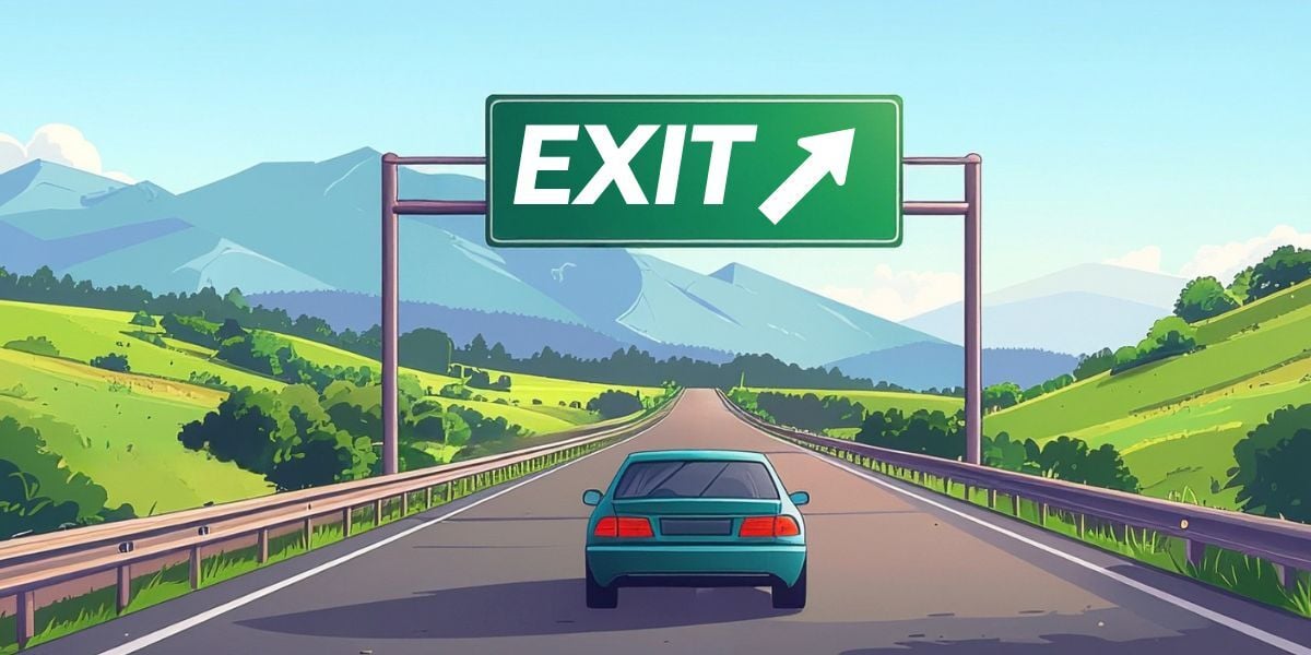 A big highway exit sign with an arrow pointing off to the right is in the center, above a highway that is flushed on either side with green hills and large mountains in the distance. A teal car drives toward the exit sign on the road. 