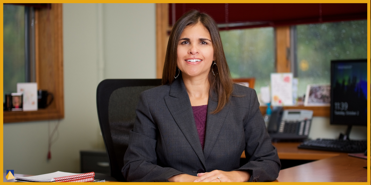Christina Ubl sits at her desk in her office